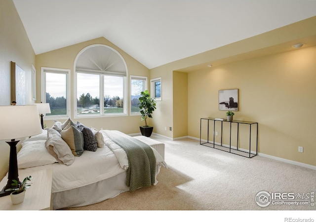 bedroom featuring vaulted ceiling and light carpet