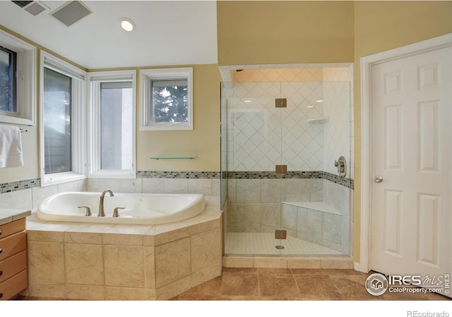 bathroom featuring vanity, tile patterned floors, and shower with separate bathtub