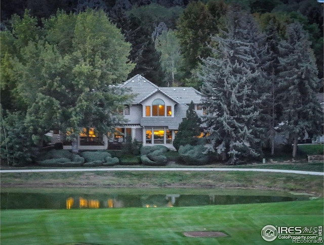 exterior space featuring a water view and a lawn