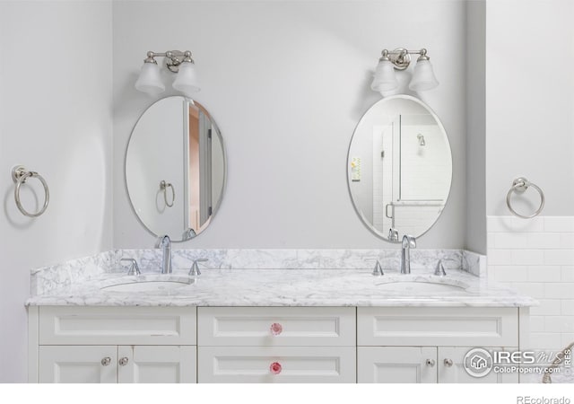 full bath with a sink and double vanity