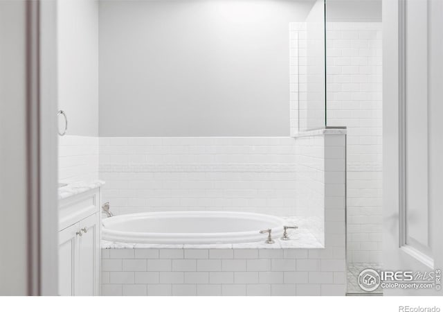 bathroom with a bath and vanity