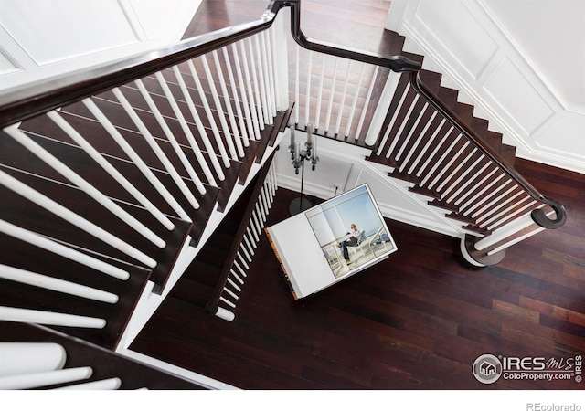 stairs featuring wood finished floors