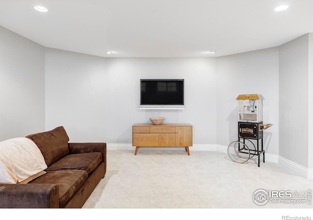 carpeted living room featuring baseboards and recessed lighting