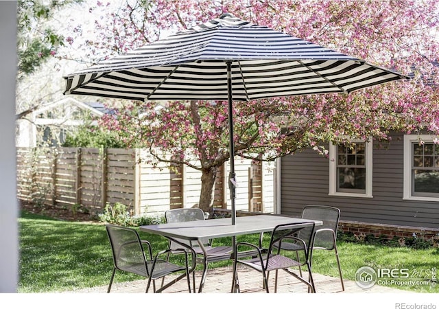 view of patio / terrace featuring outdoor dining area and fence