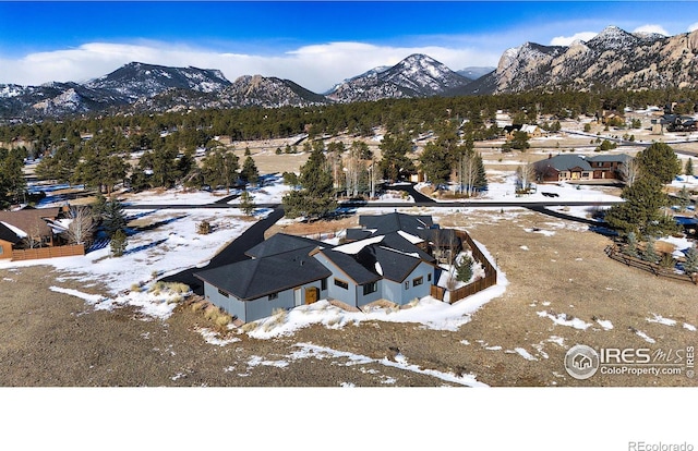 snowy aerial view featuring a mountain view