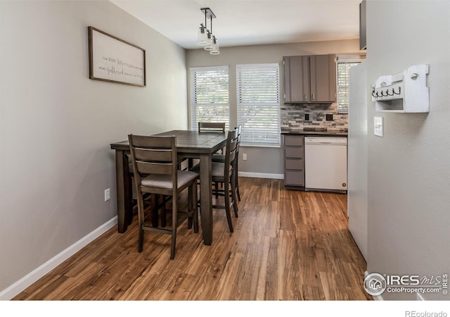 dining room with dark hardwood / wood-style flooring