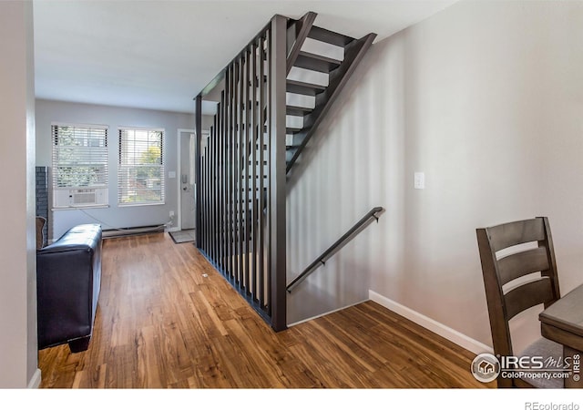 stairs featuring cooling unit and wood-type flooring