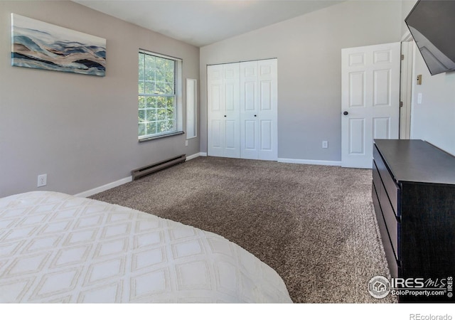 bedroom with lofted ceiling, a baseboard heating unit, a closet, and carpet flooring