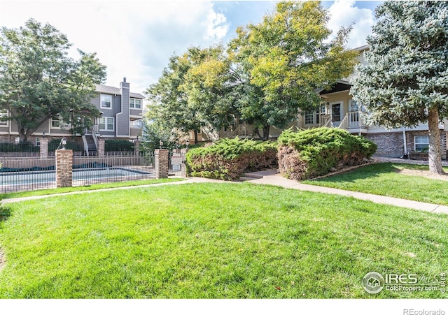 view of yard featuring a community pool