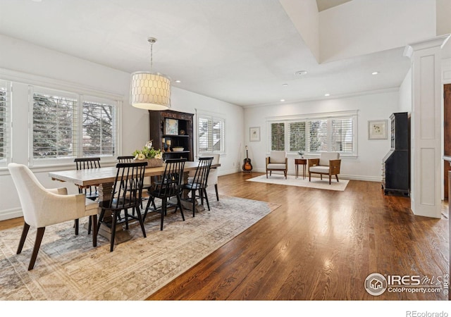 dining room featuring healthy amount of natural light, wood finished floors, baseboards, and recessed lighting