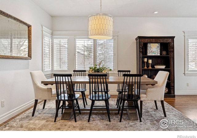 dining space with wood finished floors, baseboards, and recessed lighting