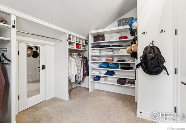 spacious closet featuring carpet flooring and lofted ceiling