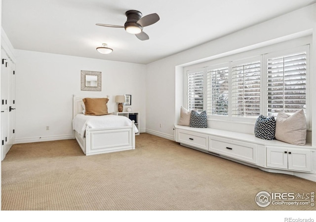 bedroom featuring baseboards, light carpet, and a ceiling fan