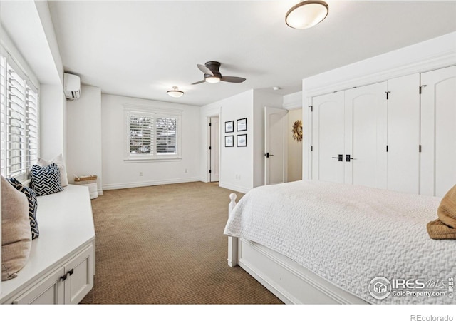 bedroom with light carpet, baseboards, and a wall mounted AC