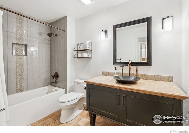 bathroom featuring toilet, vanity, tub / shower combination, and stone finish floors