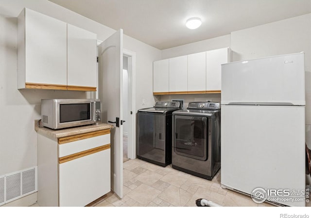 laundry room with separate washer and dryer