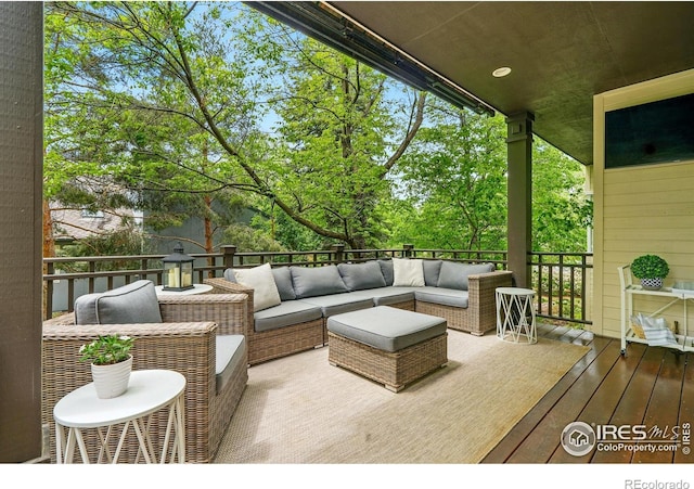 wooden deck featuring an outdoor hangout area and view of scattered trees