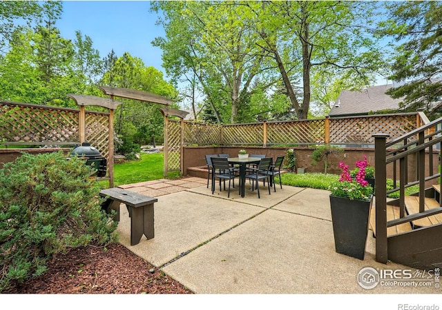 view of patio with outdoor dining area, a grill, and stairway