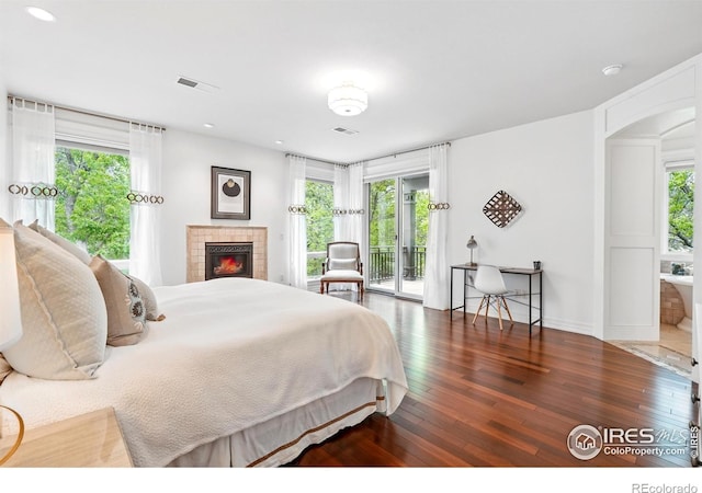 bedroom featuring access to exterior, wood-type flooring, multiple windows, and recessed lighting