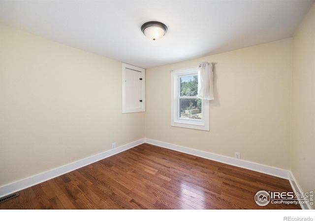 unfurnished room featuring hardwood / wood-style flooring