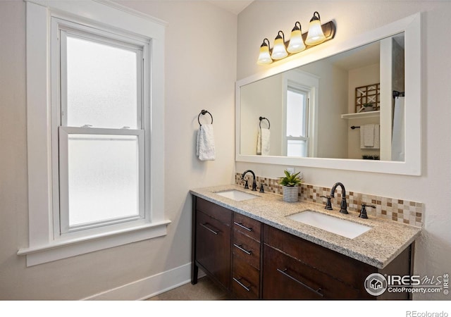 bathroom with tasteful backsplash and vanity