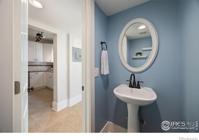 bathroom with tile patterned flooring and decorative backsplash