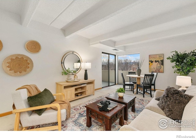 living room with beam ceiling and a textured ceiling