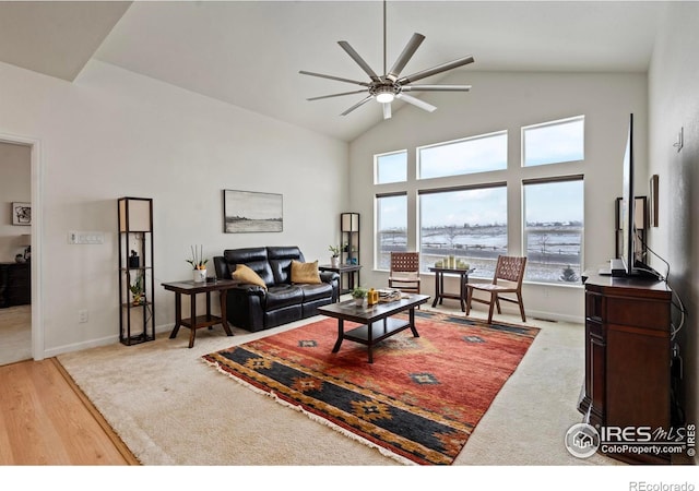 living room featuring ceiling fan, wood-type flooring, and high vaulted ceiling