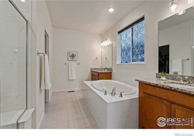 bathroom with tile patterned flooring, vanity, and independent shower and bath