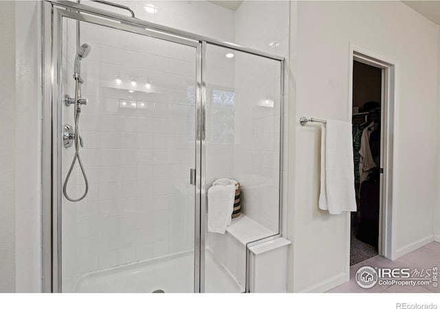 bathroom featuring a shower with shower door