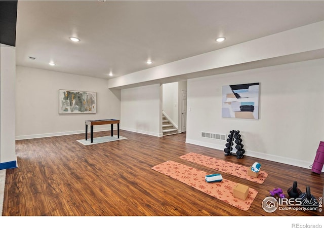 workout area featuring dark wood-type flooring