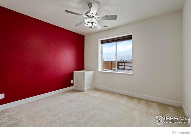 carpeted empty room featuring ceiling fan