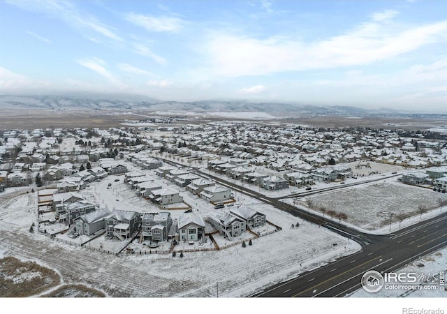 snowy aerial view featuring a mountain view