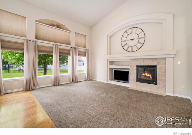 unfurnished living room featuring a fireplace and carpet