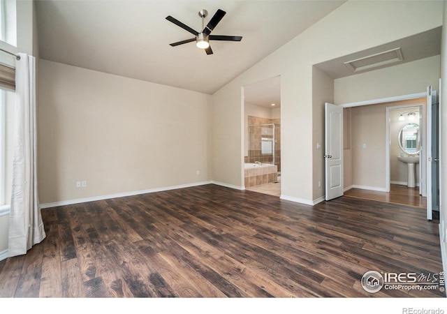 interior space featuring sink, dark wood-type flooring, vaulted ceiling, and ceiling fan