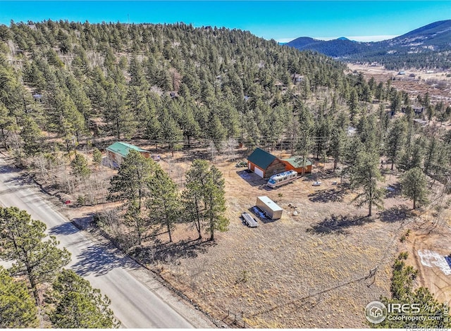 aerial view featuring a mountain view and a view of trees