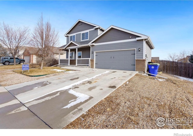 view of front of property with covered porch and a garage