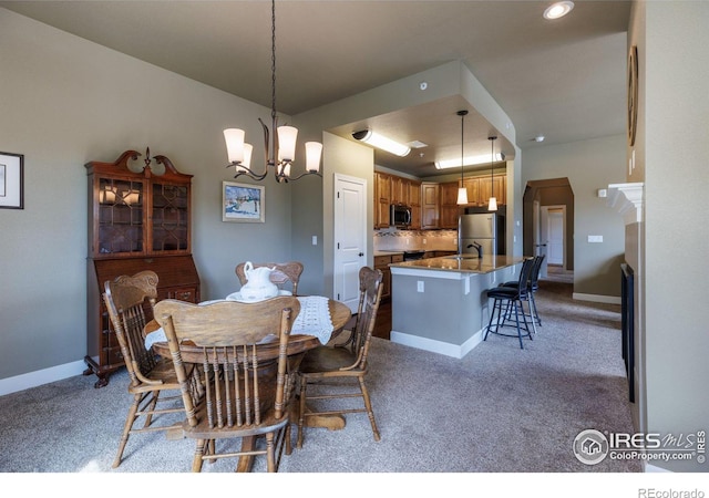 dining area featuring light colored carpet and a chandelier