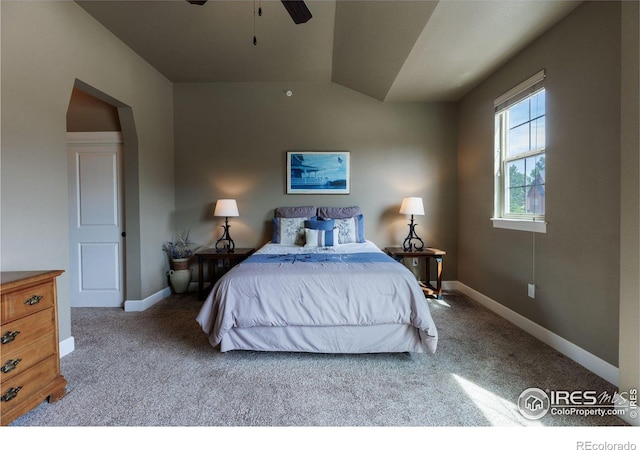 bedroom featuring vaulted ceiling, light colored carpet, and ceiling fan