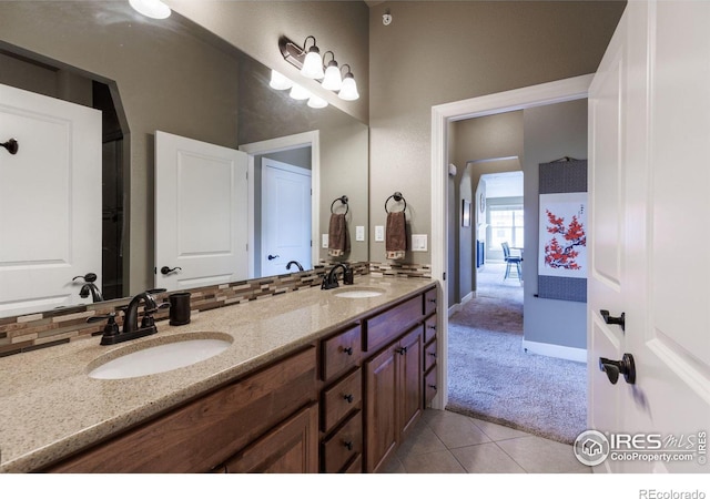 bathroom featuring vanity, tile patterned flooring, and backsplash