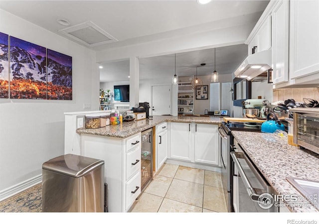 kitchen featuring white cabinetry, exhaust hood, light stone counters, and kitchen peninsula