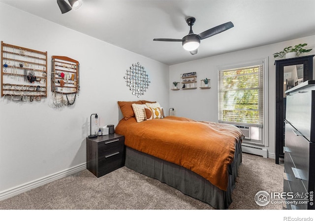 carpeted bedroom with baseboard heating and ceiling fan