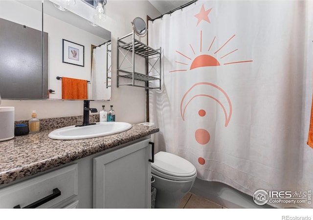 bathroom with vanity, toilet, and tile patterned flooring