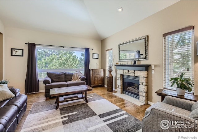 133 Eagle Canyon Cir, Lyons, CO 80540 - living room featuring a fireplace, vaulted ceiling, and light wood-type flooring