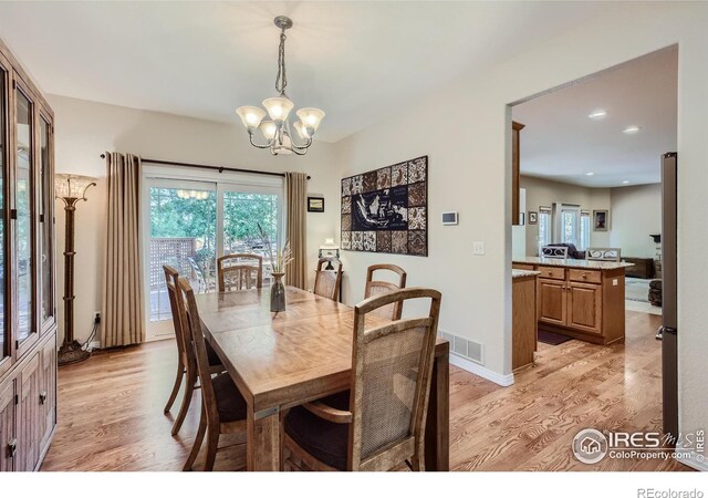 133 Eagle Canyon Cir, Lyons, CO 80540 - dining room featuring a wealth of natural light, light hardwood / wood-style flooring, and a notable chandelier