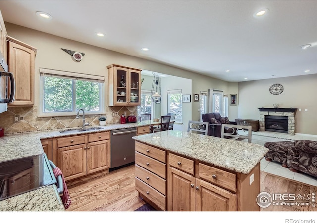 133 Eagle Canyon Cir, Lyons, CO 80540 - kitchen with appliances with stainless steel finishes, sink, backsplash, a center island, and light stone countertops