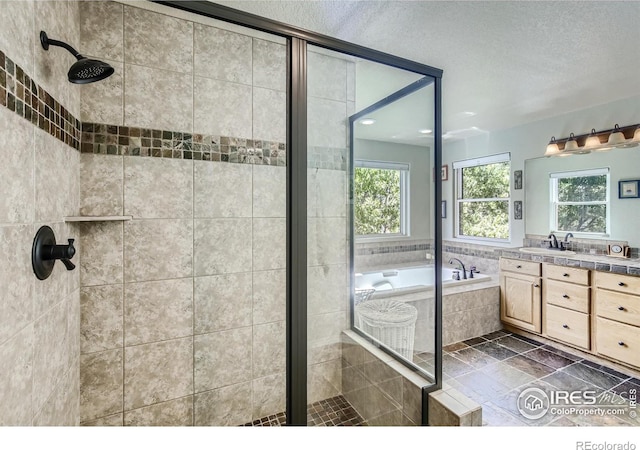 133 Eagle Canyon Cir, Lyons, CO 80540 - bathroom featuring vanity, plus walk in shower, and a textured ceiling