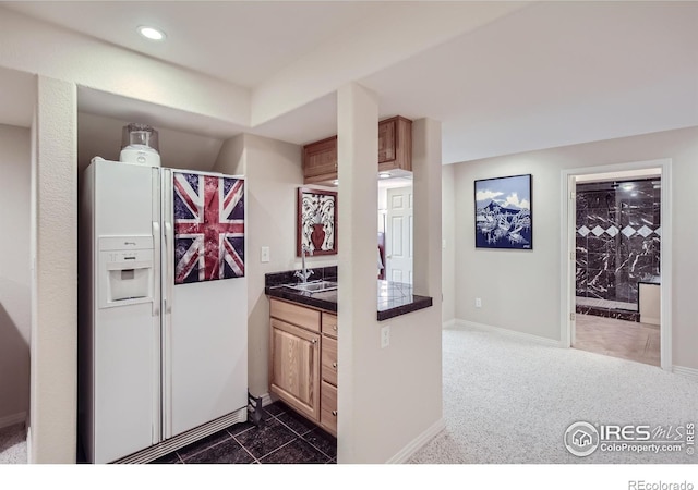 133 Eagle Canyon Cir, Lyons, CO 80540 - kitchen featuring light brown cabinetry, dark carpet, and white refrigerator with ice dispenser