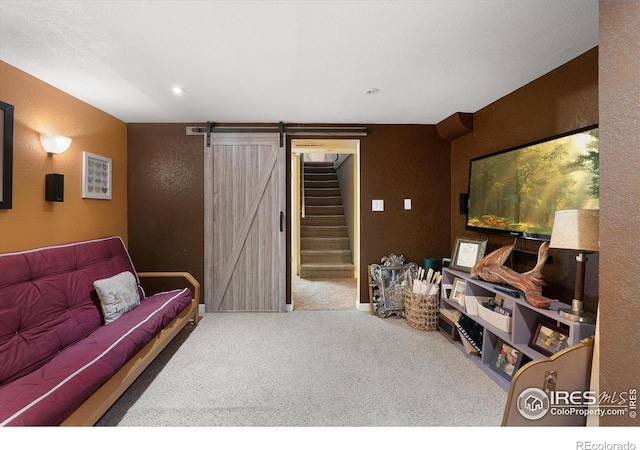 carpeted living room featuring a barn door