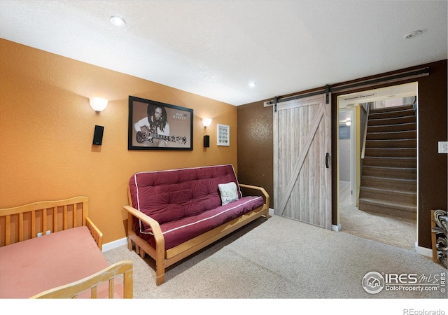 carpeted bedroom with a barn door